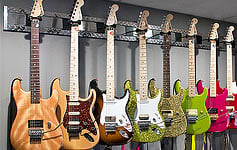 Guitar hangers for slat wall